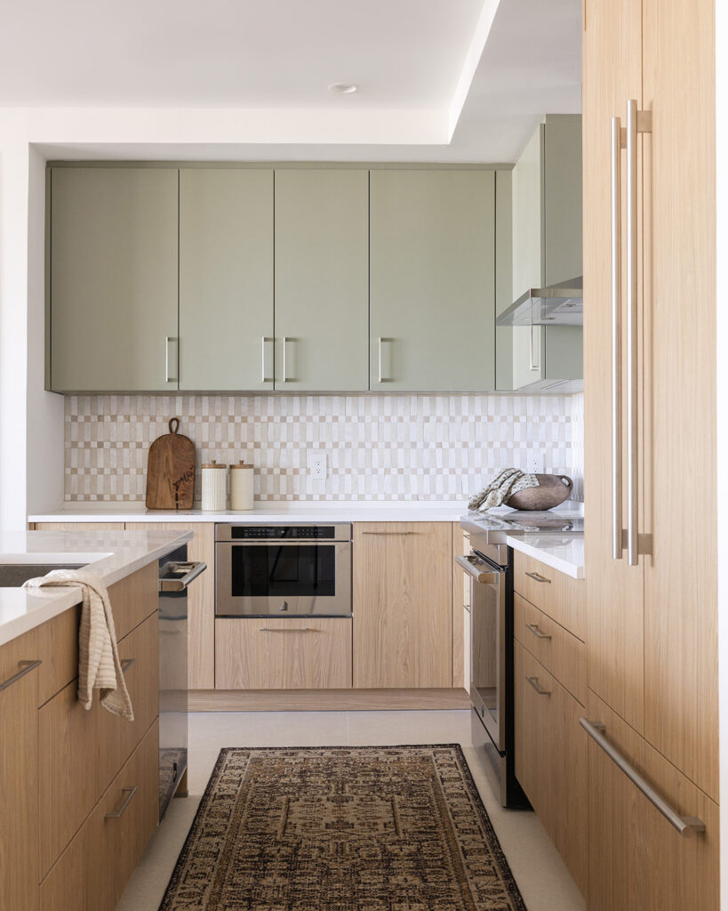 Kitchen Renovation design by Astral house in downtown St. Petersburg, Florida. Sage upper cabinets, organic hand made tile and warm oak wood finishes.